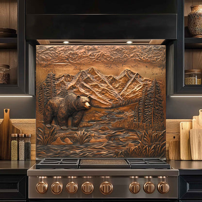Stainless steel stove with decorative mountain and bear design on the front backsplash.