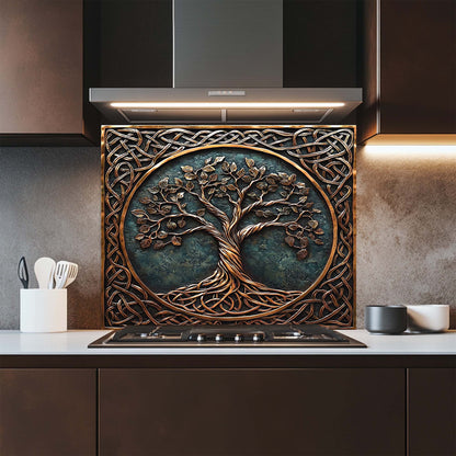 Decorative glass backsplash with tree design above a stove in a kitchen.