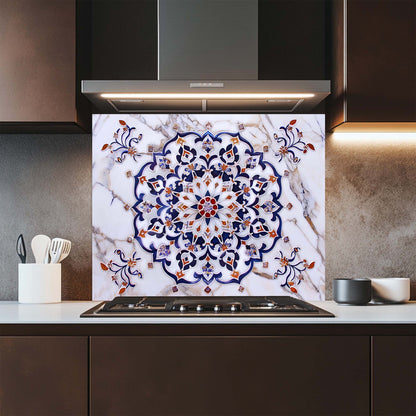 Kitchen with a decorative glass backsplash featuring a floral pattern on a marble background.