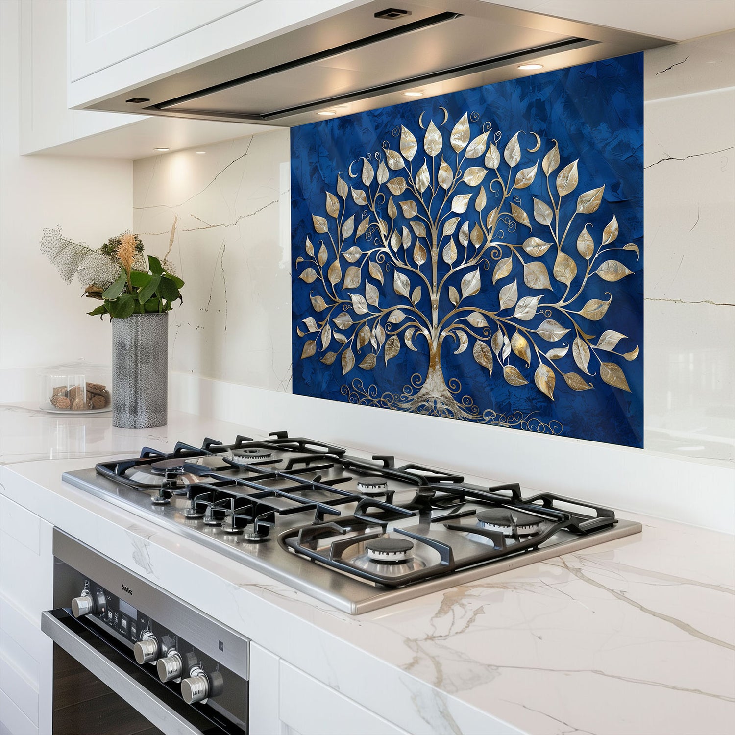 Modern kitchen with a gas stove and decorative backsplash featuring a tree design.