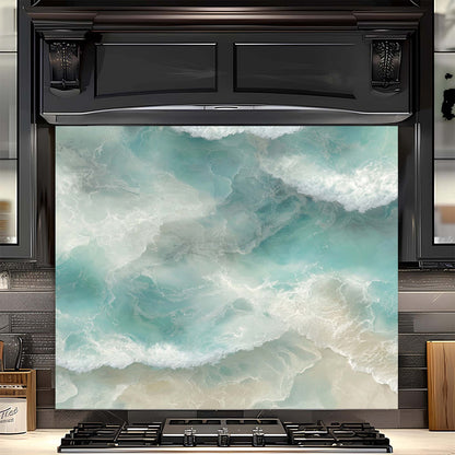 Black oven with a decorative glass backsplash featuring ocean waves and beach scene