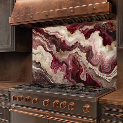Stainless steel stove with copper accents and a marbled backsplash in a kitchen setting.