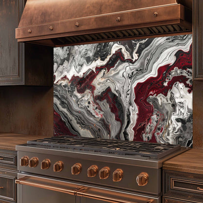 Stainless steel stove with copper accents and a marbled backsplash in a kitchen setting.