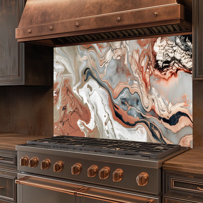 Stainless steel stove with copper accents and a decorative backsplash in a kitchen setting.