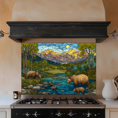 Stained glass mural of bears by a stream on a kitchen wall above a stove.