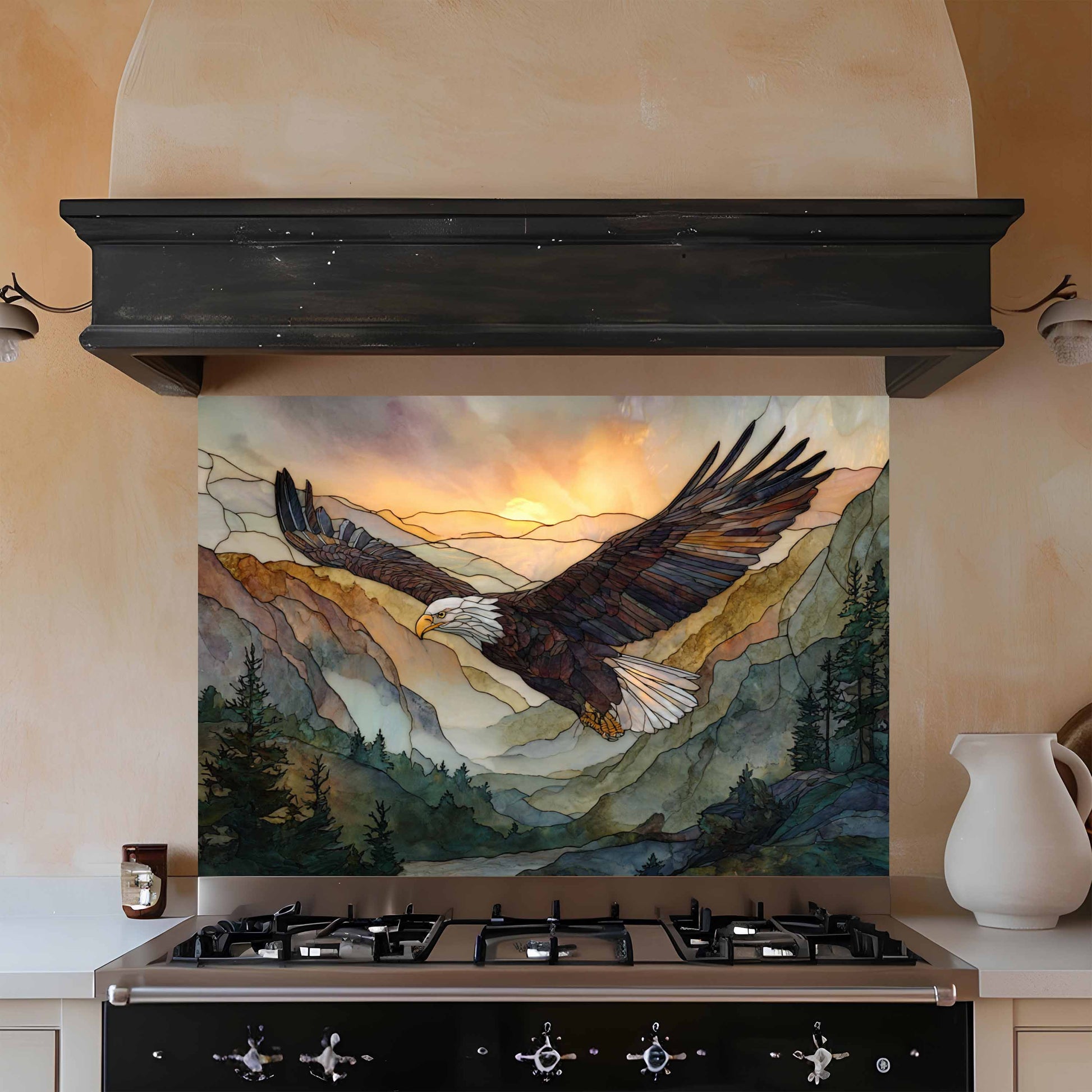 Decorative glass splashback with an eagle design above a stove in a kitchen.
