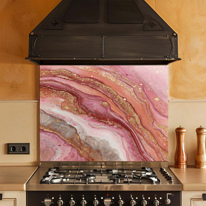 Kitchen stove with a pink and gold marbled look glass backsplash
