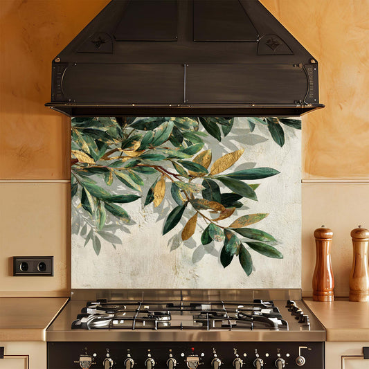 Kitchen stove with a decorative glass backsplash featuring green leaves.