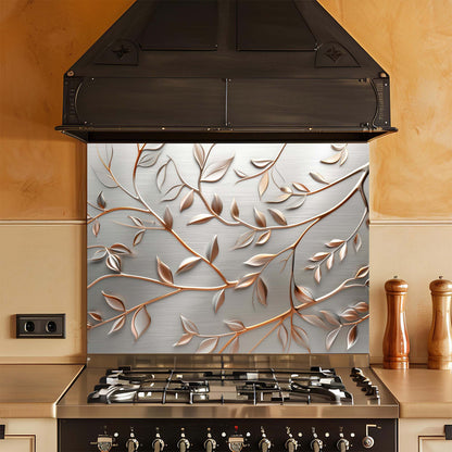 Stainless steel stove with decorative glass backsplash featuring leaf patterns in a kitchen setting.