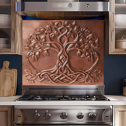 Stainless steel stove with decorative copper tree glass backsplash in a kitchen setting