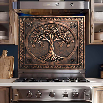 Stainless steel stove with decorative copper design glass backsplash featuring a tree design in a kitchen setting.