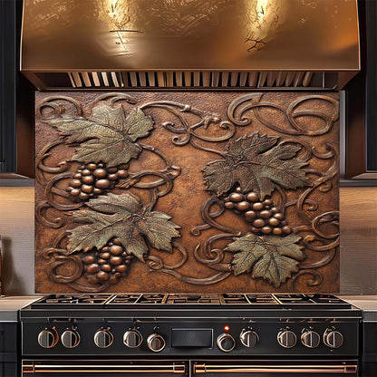 Decorative copper look glass backsplash with leaf and grape design above a stove.