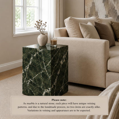 Marble side table in a living room setting with a sofa and decor items.