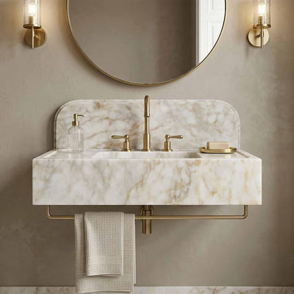 Bathroom vanity with marble countertop, gold fixtures, and round mirror.