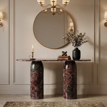 Decorative marble console table with a round mirror, candle, and vase in a stylish room.