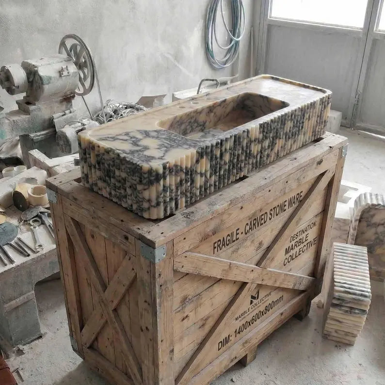 Marble sink on a wooden crate in a workshop setting