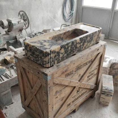 Marble sink on a wooden crate in a workshop setting