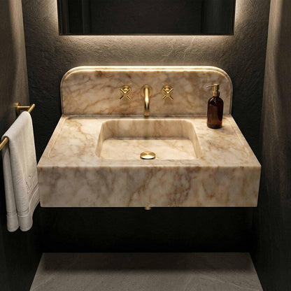 Marble sink with gold faucet in a bathroom setting