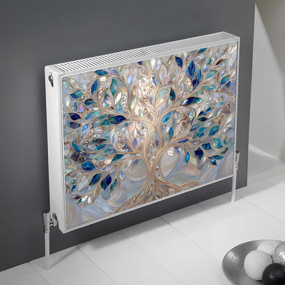 Decorative magnetic radiator cover with tree design on a gray wall.