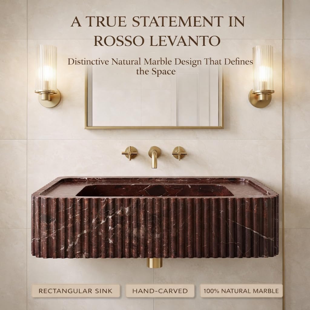 Marble sink with gold fixtures in a bathroom setting, featuring text about Rosso Levanto marble.