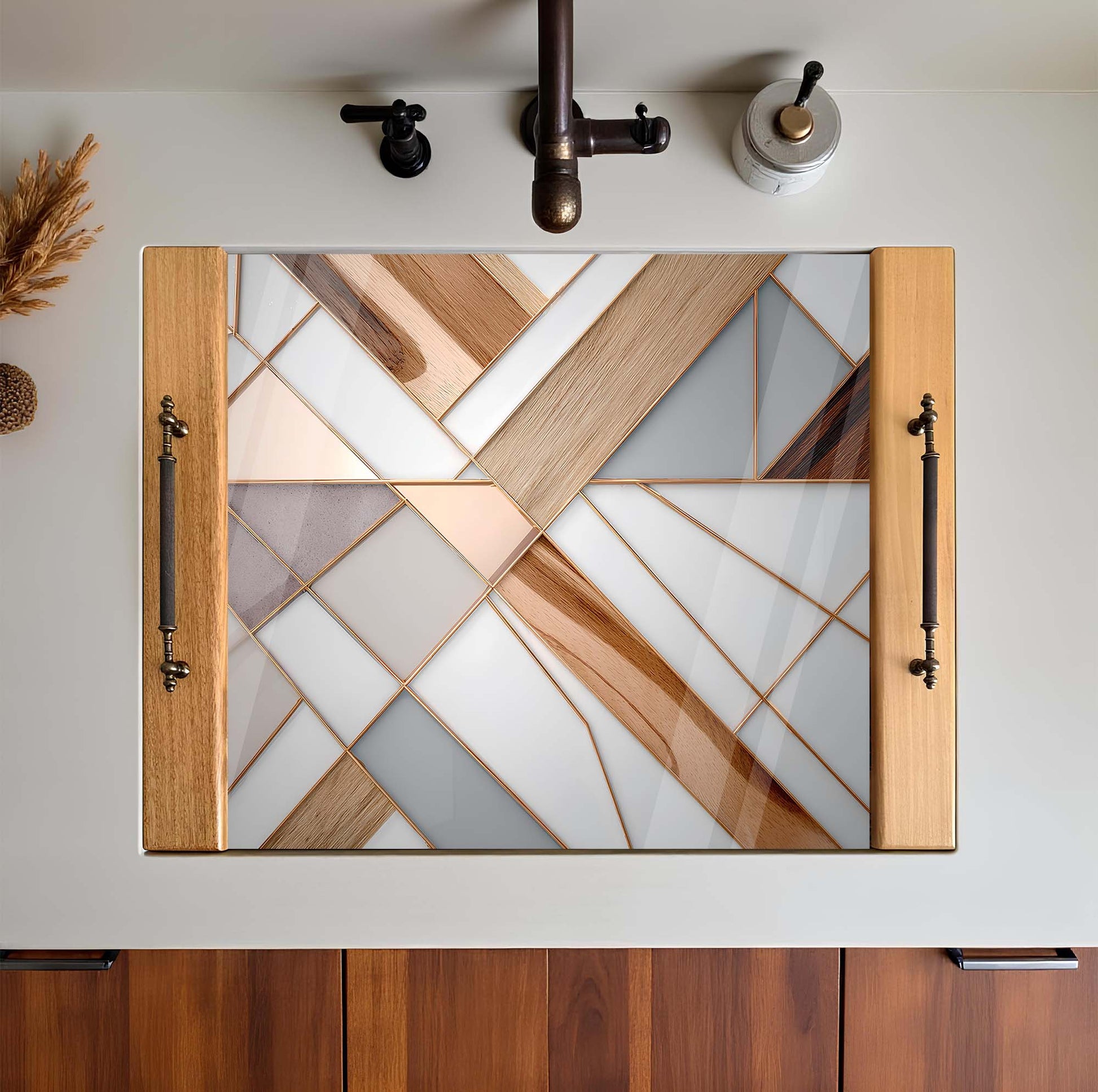 Decorative mirror with geometric glass design on a white wall.