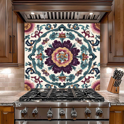 Decorative glass backsplash with intricate floral pattern above a stainless steel stove in a kitchen.