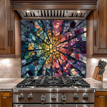 Stainless steel gas stove with a colorful mosaic glass backsplash in a kitchen setting.