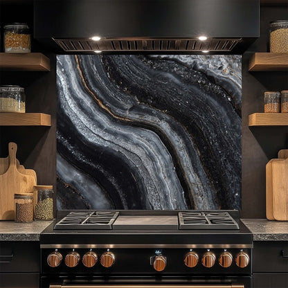 Modern kitchen with a black stove and glass splashback