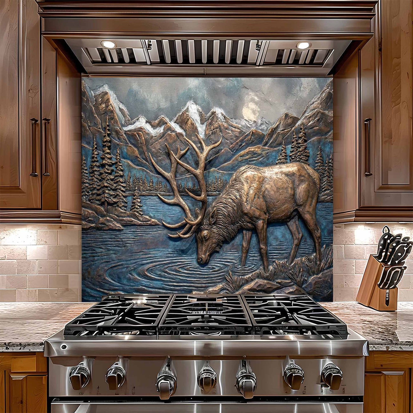 Stainless steel stove with decorative elk and mountain glass backsplash in a kitchen setting