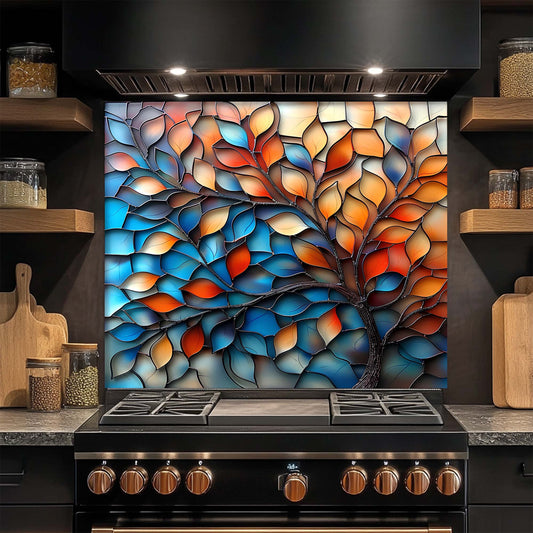 Stylized tree design on a kitchen glass backsplash above a stove.