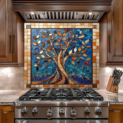 Stainless steel gas stove with a decorative mosaic glass backsplash featuring a tree design.