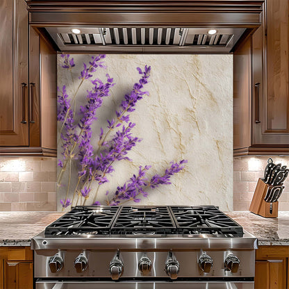 Stainless steel gas stove with decorative lavender glass backsplash in a kitchen setting