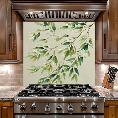 Stainless steel gas stove with decorative green leaf pattern backsplash on the wall behind it.