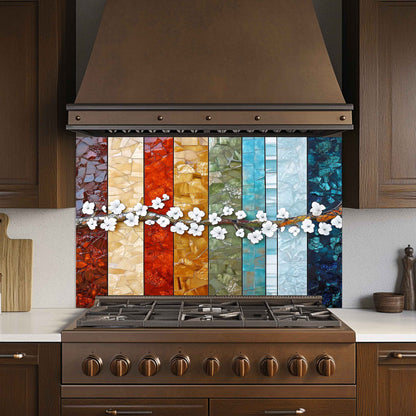 Stainless steel stove with a colorful mosaic backsplash in a kitchen setting.