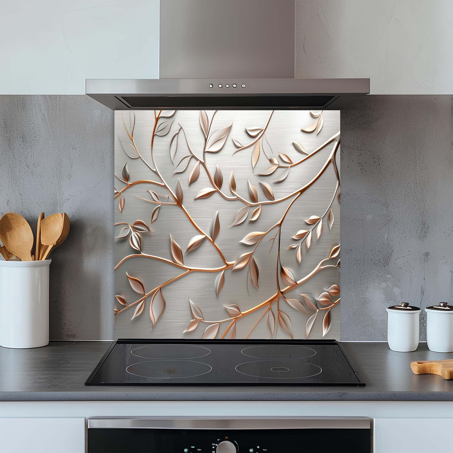 Decorative glass splashback with leaf pattern above a kitchen stove.