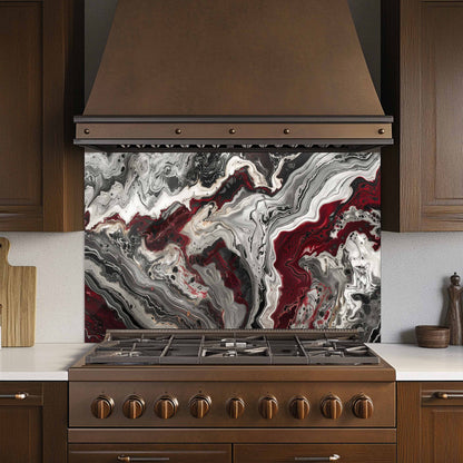 Kitchen stove with a marbled backsplash and brown hood