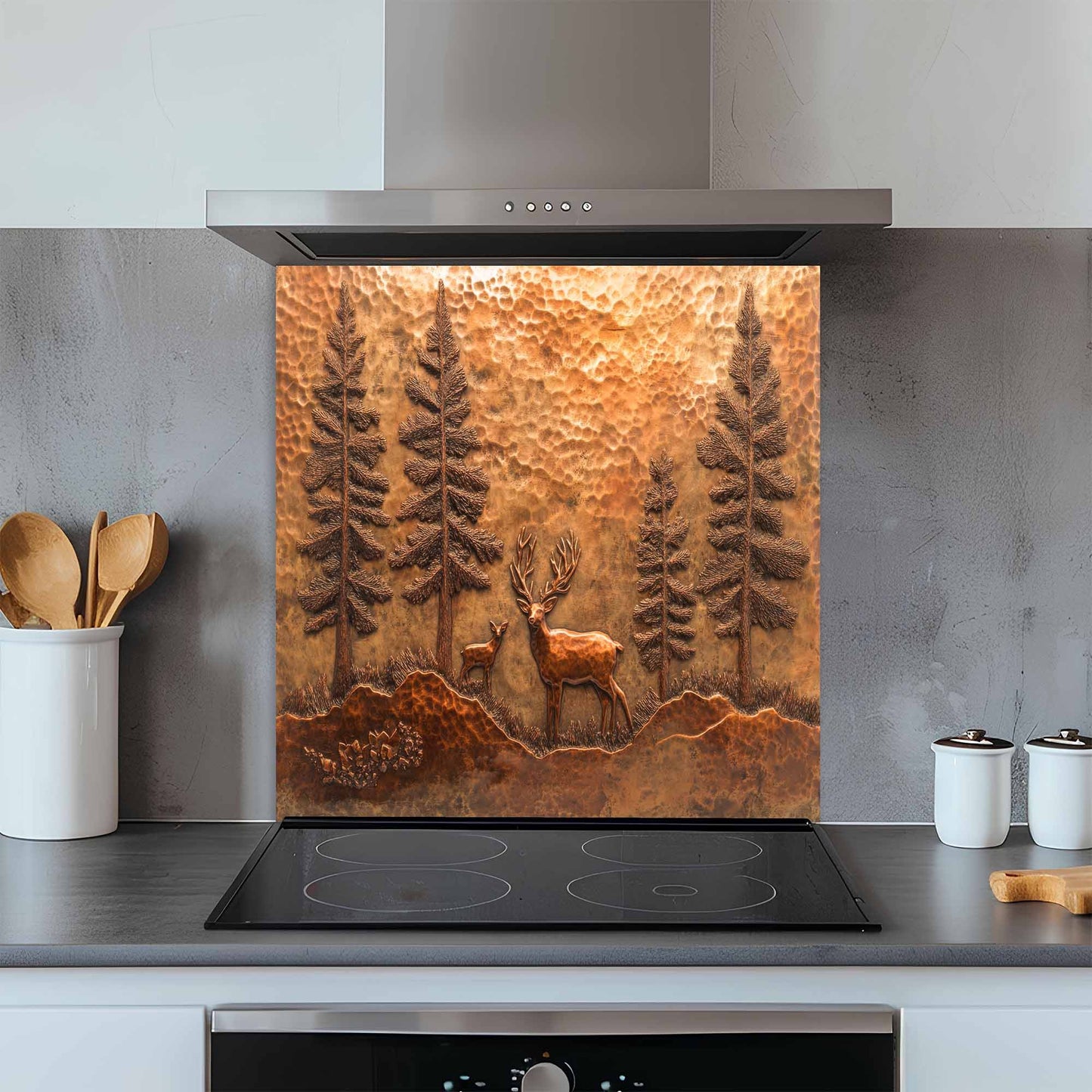Kitchen with a decorative copper look glass backsplash featuring a deer and trees above a stove.