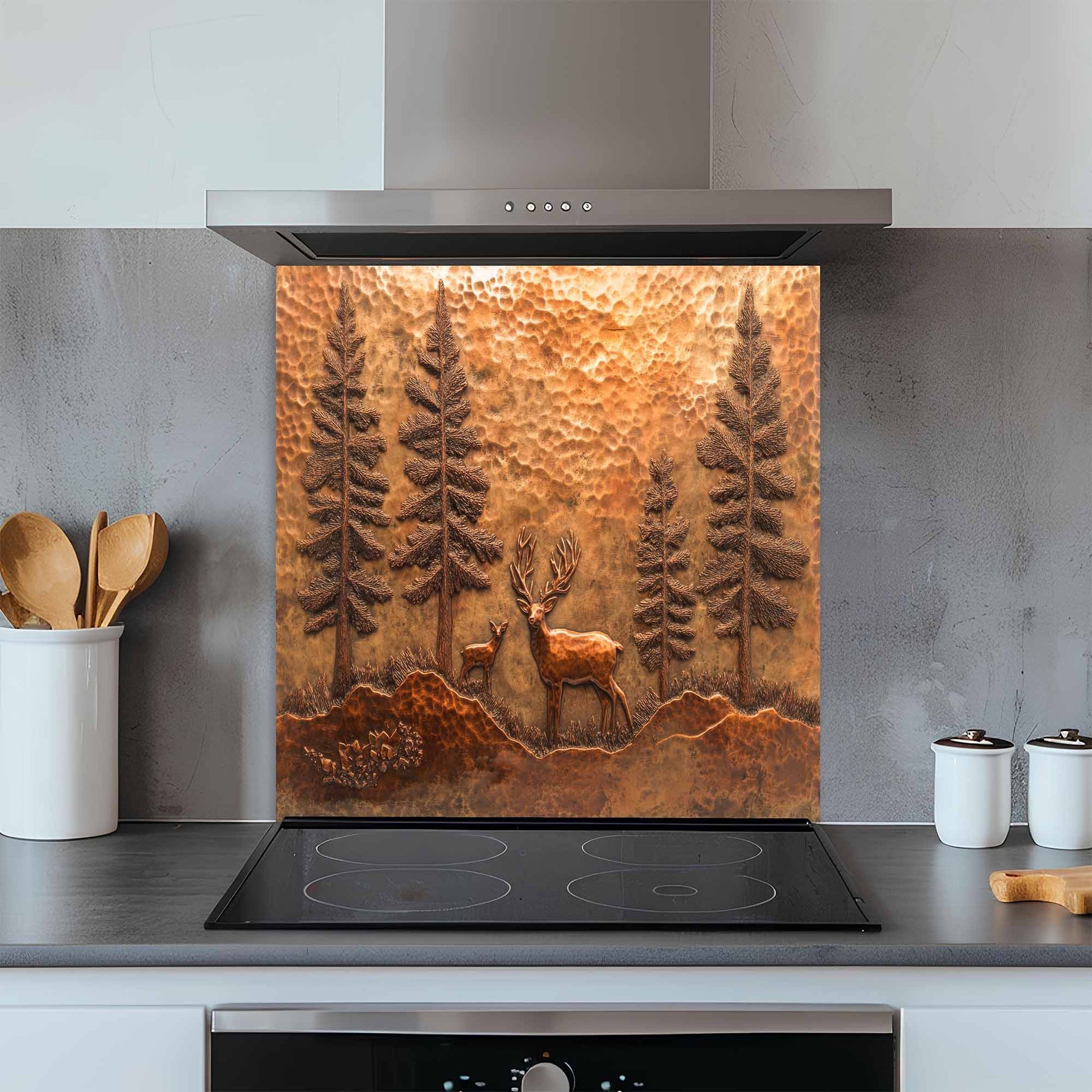 Kitchen with a decorative copper look glass backsplash featuring a deer and trees above a stove.