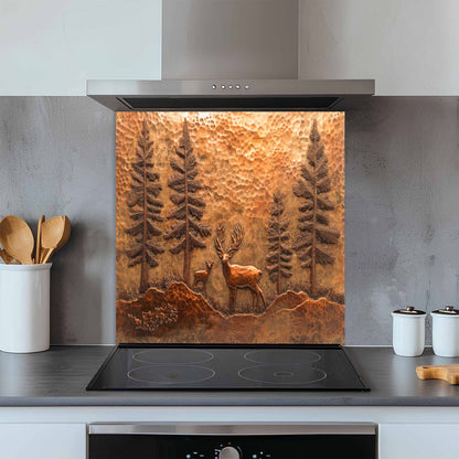 Kitchen with a decorative copper look glass backsplash featuring a deer and trees above a stove.