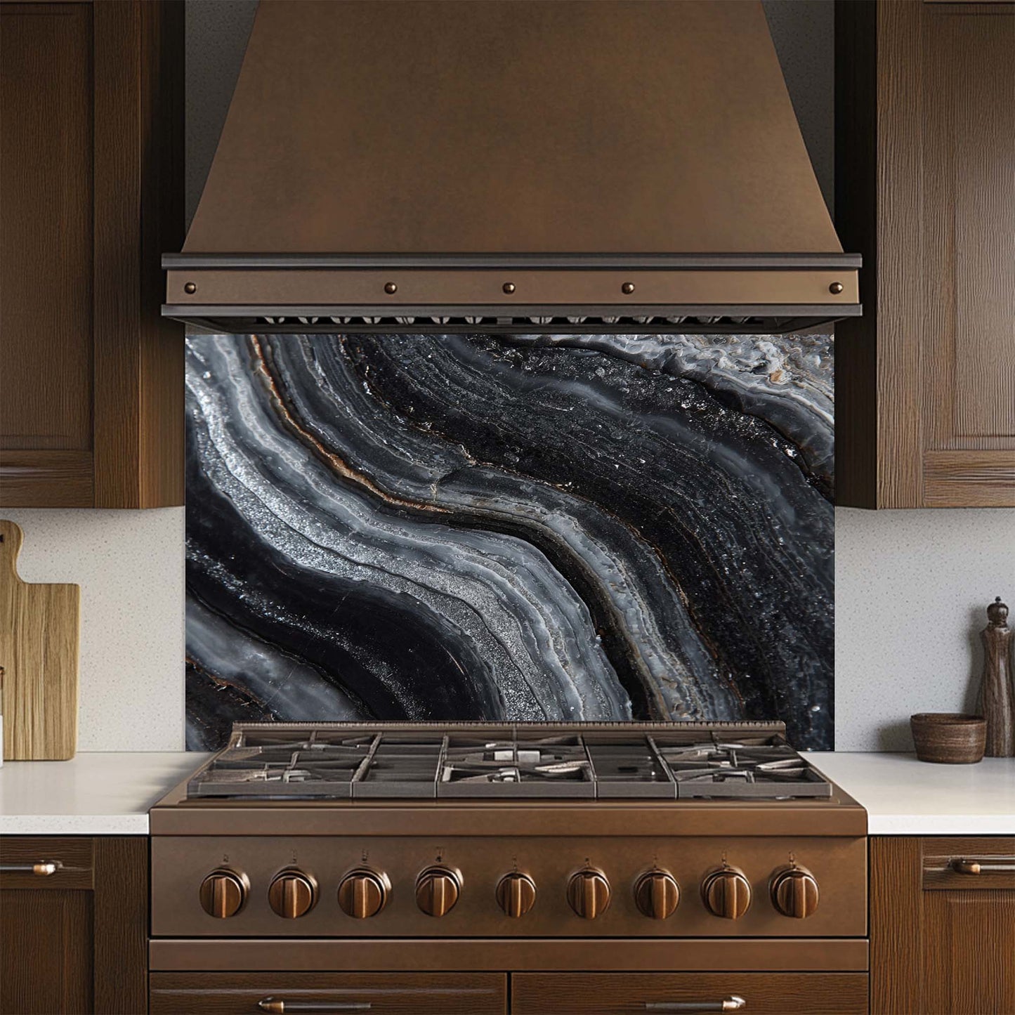 Kitchen stove with a decorative glass splashback featuring black and gray agate patterns.
