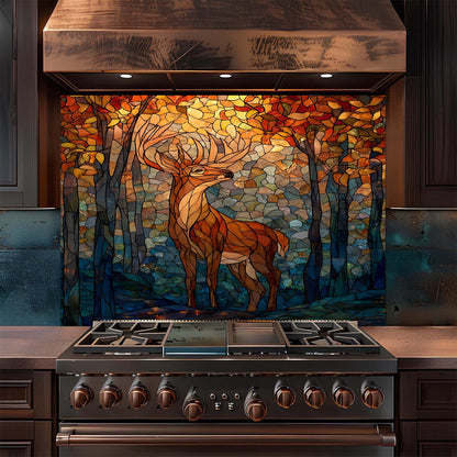 Stainless steel stove with a decorative glass backsplash featuring a deer in a forest design.