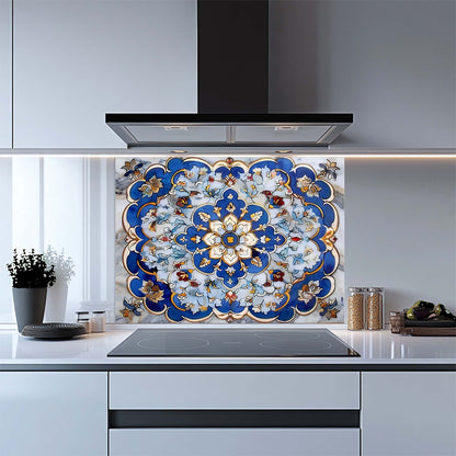 Decorative kitchen backsplash with a blue and gold floral pattern above a stove.