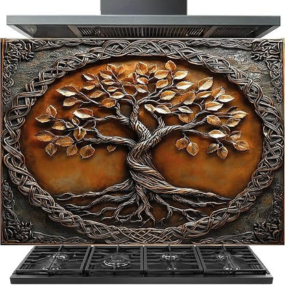 A decorative wall-mounted range hood and vent cover featuring a large embossed tree of life design with metallic bronze and copper tones, shown installed above a black gas range hood and cooktop.