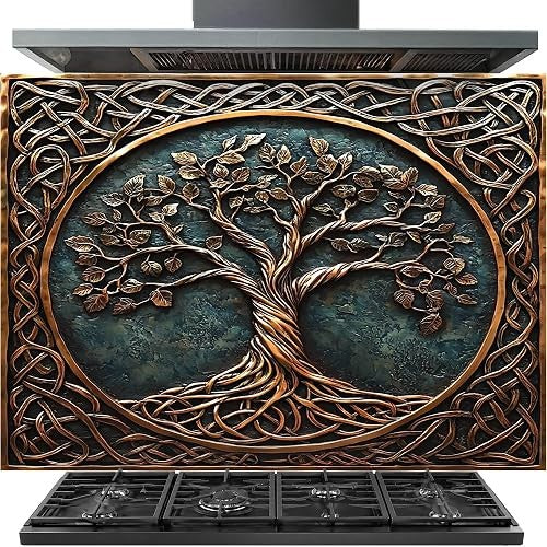 A decorative range hood cover or fireplace front panel featuring a raised tree of life design with copper-toned branches and roots over a dark teal-green background, surrounded by an intricate knot pattern. A black range hood is visible above and a black gas cooktop is visible below on a white background.