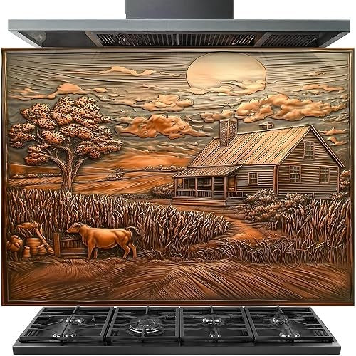 A large decorative range hood or vent cover with a detailed rustic farm landscape relief design, featuring a cabin, tree, cow, wheat field, and sun in warm copper and brown tones, installed above a black gas stove.
