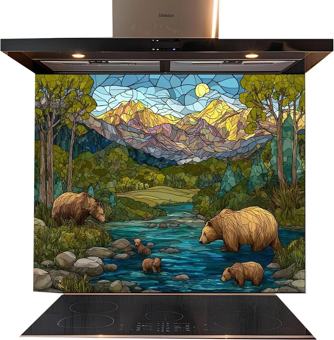 A kitchen range hood and built-in cooktop with a large stained-glass style mountain river scene panel behind them. The artwork shows bears by a blue river with green trees and purple/yellow mountains under a yellow sun.
