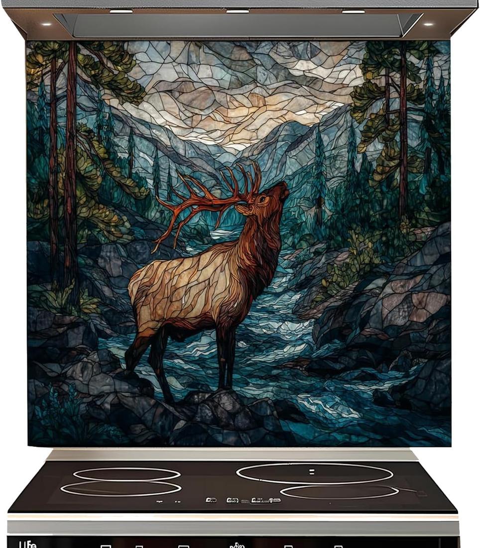 A large decorative wall mural or backsplash panel featuring a stained-glass-style mountain landscape with an elk in the foreground, installed above a black induction cooktop.