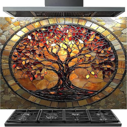 A large oval stained-glass style wall tile featuring a tree of life design in amber, orange, red, and brown tones, shown installed above a black gas range hood and cooktop.