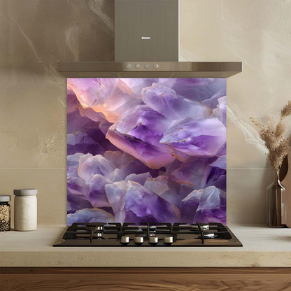 Kitchen stove with a decorative glass backsplash featuring purple and white rock-like design.