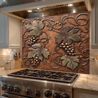 Decorative glass backsplash with grapevine design above a stove in a kitchen.